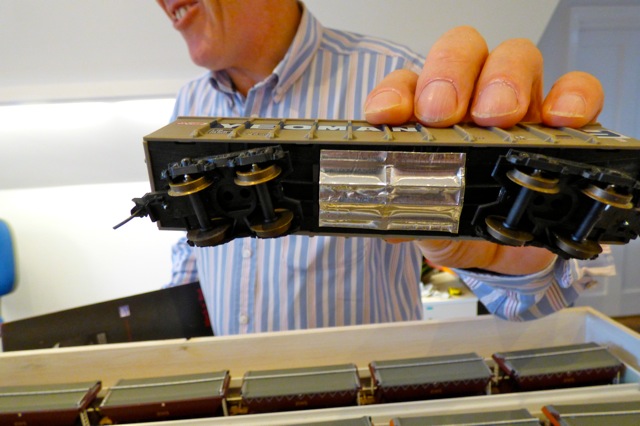Aluminium Foil Tape on the bottom of a model train carriage - being fitted
